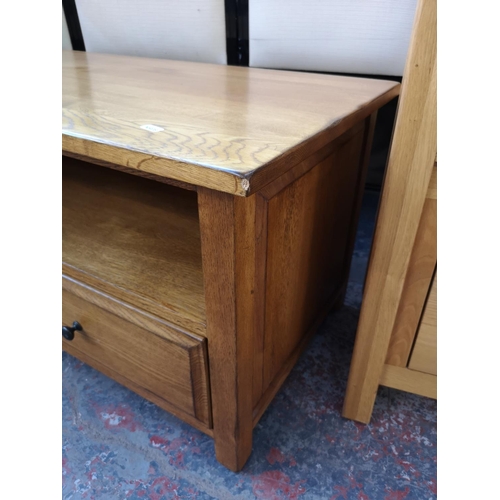 1131 - A modern oak TV stand with two lower drawers - approx. 47cm high x 110cm wide x 48cm deep