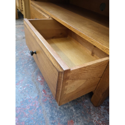 1131 - A modern oak TV stand with two lower drawers - approx. 47cm high x 110cm wide x 48cm deep