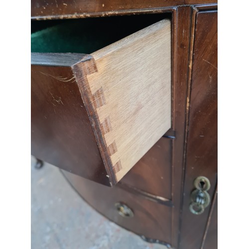 1065C - A Regency style mahogany sideboard with three central drawers and two outer cupboard doors - approx.... 