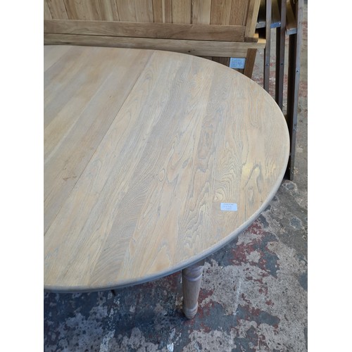 1065D - A modern limed oak extending dining table - approx. 75cm high x 110cm wide x 150cm long