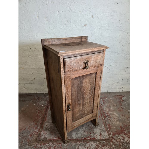 1010A - An early 20th century oak bedside cabinet - approx. 93cm high x 45cm wide x 32cm deep