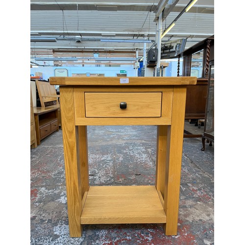 1129 - A modern solid oak single drawer two tier side table - approx. 85.5cm high x 65cm wide x 35cm deep