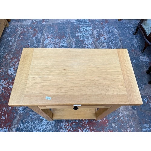 1129 - A modern solid oak single drawer two tier side table - approx. 85.5cm high x 65cm wide x 35cm deep