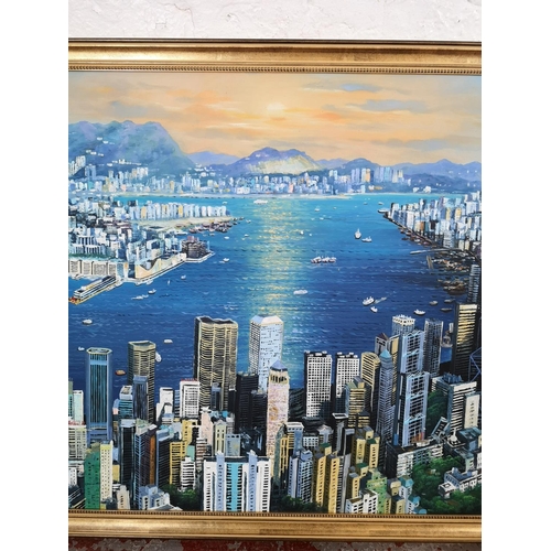 1162 - A gilt framed oil on canvas of a Hong Kong scene - approx. 98cm wide x 67cm high