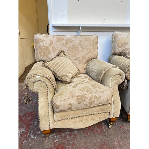 1023A - A Regency style beige floral upholstered three piece lounge suite comprising two seater sofa and two... 