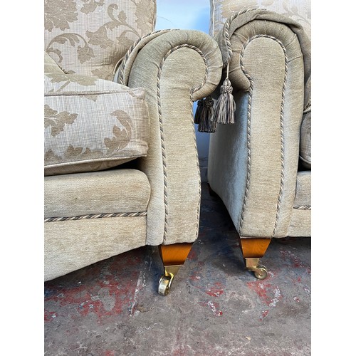 1023A - A Regency style beige floral upholstered three piece lounge suite comprising two seater sofa and two... 