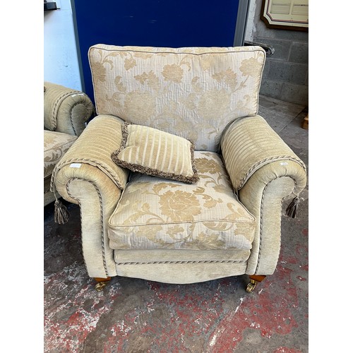 1023A - A Regency style beige floral upholstered three piece lounge suite comprising two seater sofa and two... 