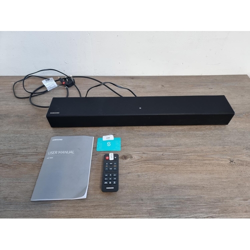 1509 - A Samsung HW-T400 soundbar with instruction manual and remote control