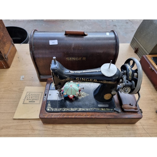 1547 - A cased c.1912 no.99 hand crank sewing machine with attachments - serial no. F2584120