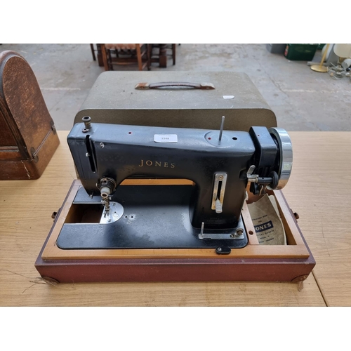 1548 - A cased Jones model C electric sewing machine with instruction manual