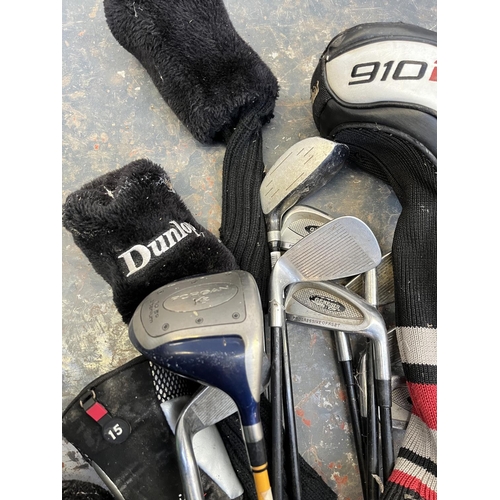 A collection of various golf clubs to include Dunlop Max, Meridan HMG35