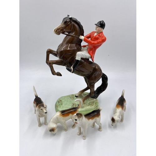 1167 - Five Beswick figurines, one Rearing Huntsman model no. 868 and four hunting hounds