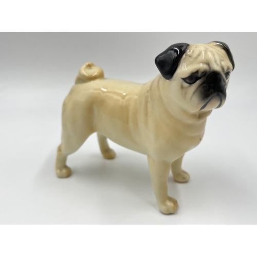 1170 - Two Beswick pug figurines, one being CH. Cutmil Cupie