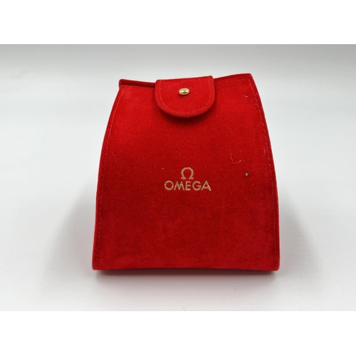 2184 - An original red velvet Omega watch pouch and cushion