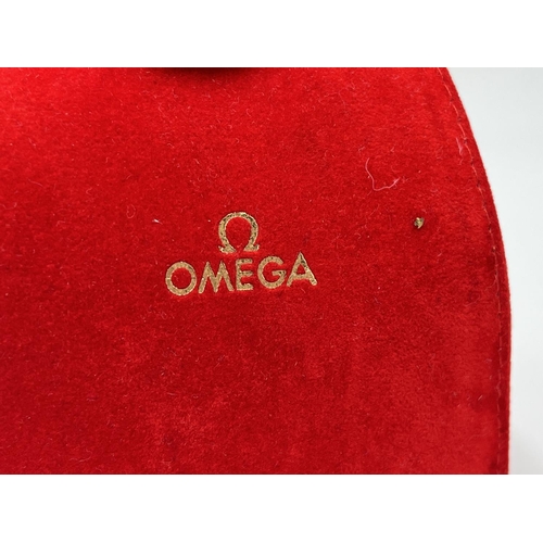 2184 - An original red velvet Omega watch pouch and cushion