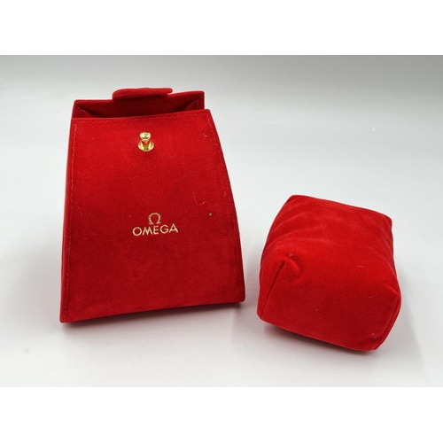 2184 - An original red velvet Omega watch pouch and cushion