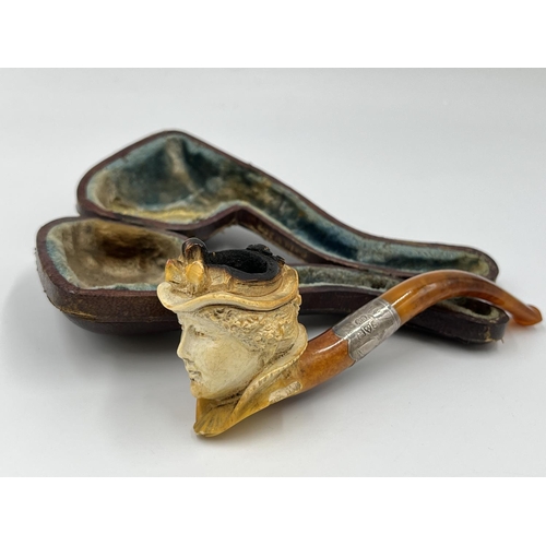 2261 - Three leather cased carved Meerschaum smoking pipes with hallmarked sterling silver collars and ambe... 