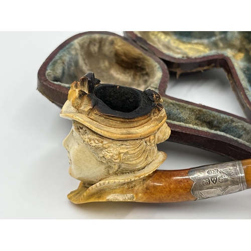 2261 - Three leather cased carved Meerschaum smoking pipes with hallmarked sterling silver collars and ambe... 