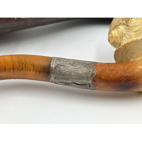 2261 - Three leather cased carved Meerschaum smoking pipes with hallmarked sterling silver collars and ambe... 