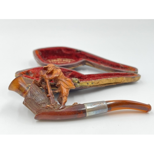 2261 - Three leather cased carved Meerschaum smoking pipes with hallmarked sterling silver collars and ambe... 