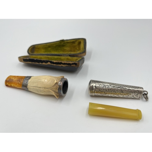 2262 - Two cheroot holders, one hallmarked Birmingham silver - dated 1911 and one cased Meerschaum with amb... 