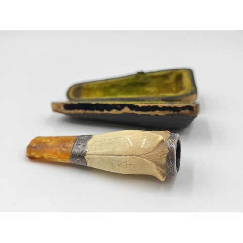 2262 - Two cheroot holders, one hallmarked Birmingham silver - dated 1911 and one cased Meerschaum with amb... 