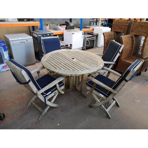 A five piece wooden garden dining set comprising four chairs and one table