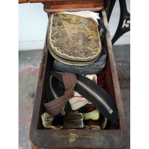 1545 - A 19th century Singer treadle sewing machine - serial no. 15119 637 with accessories