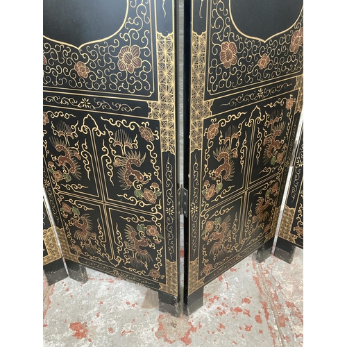 1007A - A black lacquered and hand painted four section folding dressing screen/room divider - approx. 183cm... 