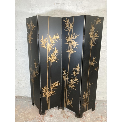 1007A - A black lacquered and hand painted four section folding dressing screen/room divider - approx. 183cm... 