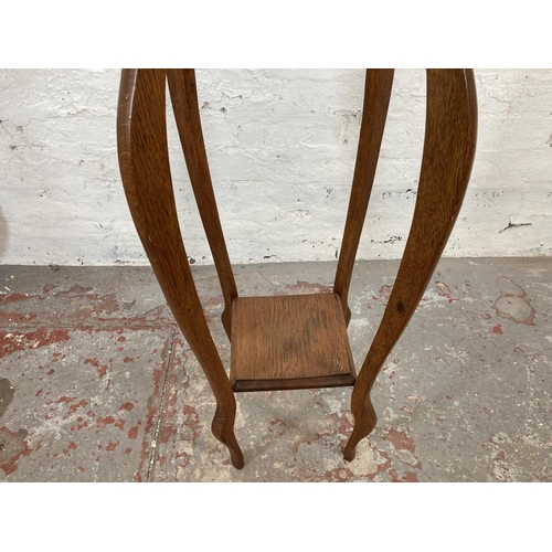 1035A - Two items, one early 20th century oak two tier plant stand - approx. 91cm high and one early 20th ce... 