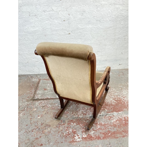 1048A - A late 19th/early 20th century mahogany and beige upholstered rocking chair