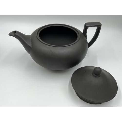 279 - A Wedgwood black basalt three piece tea set comprising 13cm teapot, 7.5cm milk jug and 6.5cm bowl