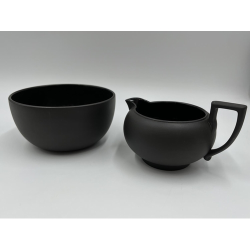 279 - A Wedgwood black basalt three piece tea set comprising 13cm teapot, 7.5cm milk jug and 6.5cm bowl