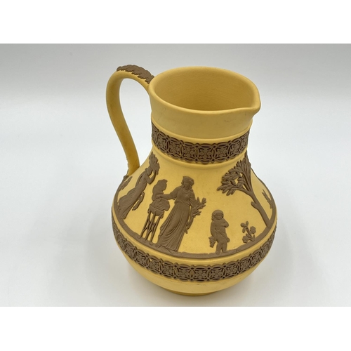 289 - A Wedgwood Taupe on cane Jasperware Etruscan jug - approx. 13cm high