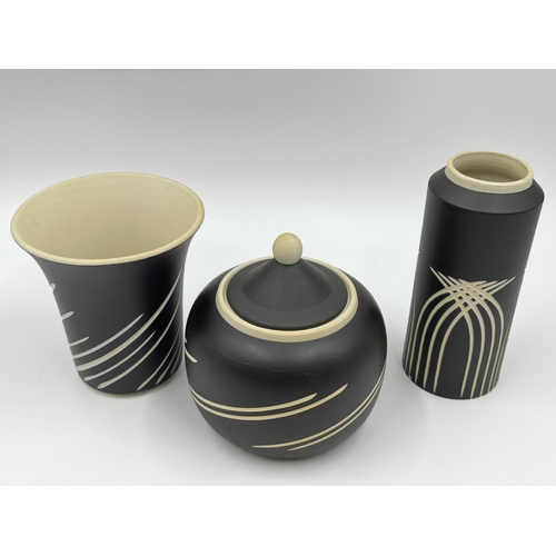 297 - Three pieces of Wedgwood Symmetry pattern black Jasperware, two vases and one jar and cover - larges... 