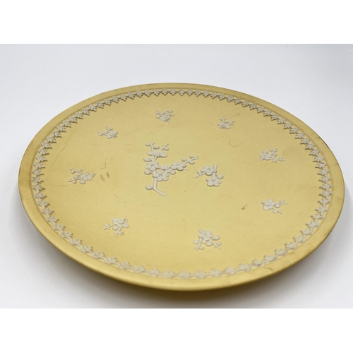 303 - Two pieces of Wedgwood primrose yellow Prunus Blossom Jasperware, one 12.5cm bowl and one 21cm plate