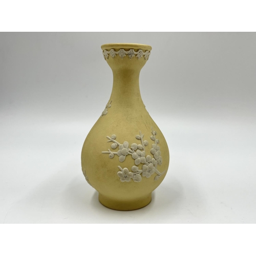 304 - Two Wedgwood primrose yellow Prunus Blossom vases - largest approx. 14cm high