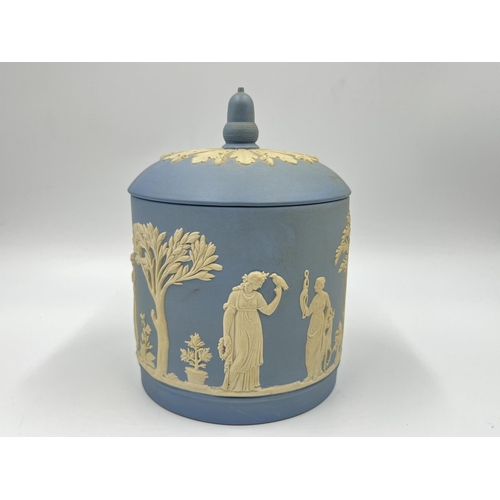 310 - Two pieces of Wedgwood pale blue Jasperware, one boxed biscuit barrel - approx. 17cm high and one pe... 