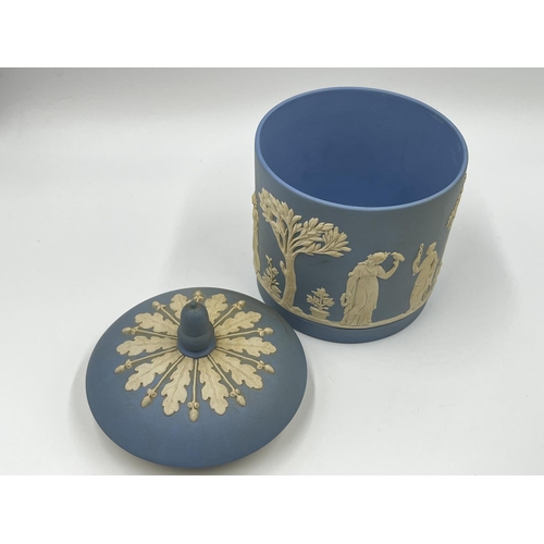 310 - Two pieces of Wedgwood pale blue Jasperware, one boxed biscuit barrel - approx. 17cm high and one pe... 