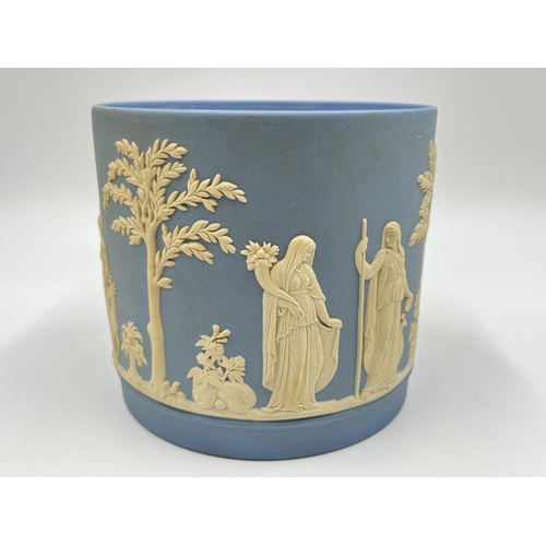 310 - Two pieces of Wedgwood pale blue Jasperware, one boxed biscuit barrel - approx. 17cm high and one pe... 