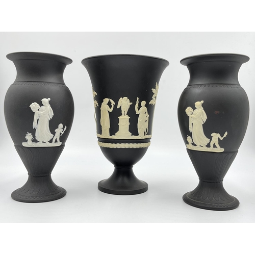 318 - Three Wedgwood black Jasperware vases, two 18.5cm and one 19cm