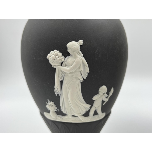 318 - Three Wedgwood black Jasperware vases, two 18.5cm and one 19cm