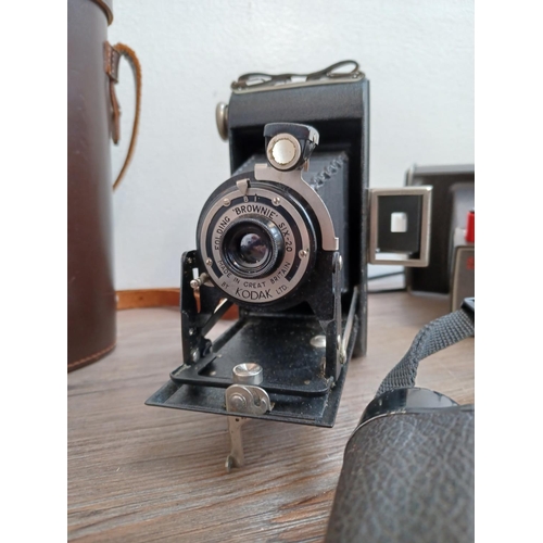 765 - Four items, one cased pair of Ross Stepmur 10 x 50 binoculars, one Kodak Brownie Six-20 folding came... 