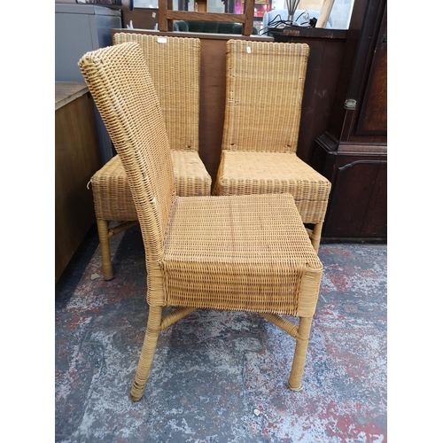 137 - A set of four modern wicker dining chairs