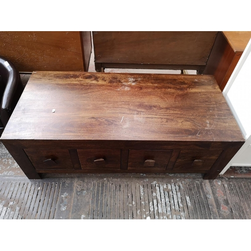 104 - Two pieces of mango wood furniture, one TV stand with four lower drawers and one rectangular coffee ... 