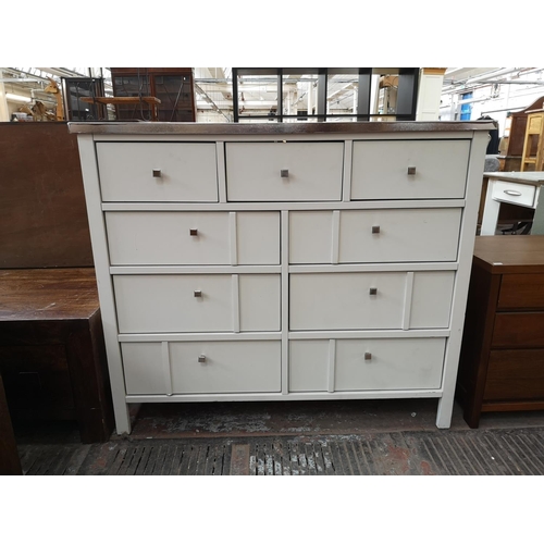 105 - A modern white laminate chest of three short and six long drawers