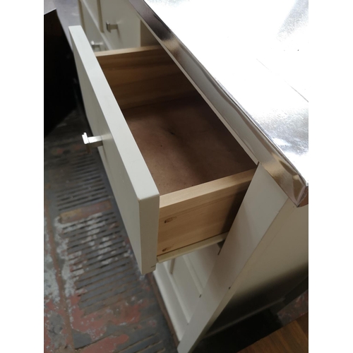 105 - A modern white laminate chest of three short and six long drawers