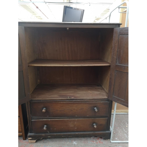 107 - An oak linen fold cabinet with two doors and two lower drawers