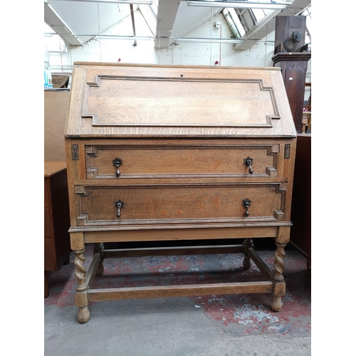 113 - An early 20th century oak geometric carved bureau with barley twist supports